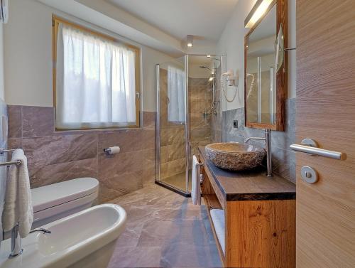 a bathroom with a sink and a toilet and a sink at Chalet Degli Angeli in Folgarida