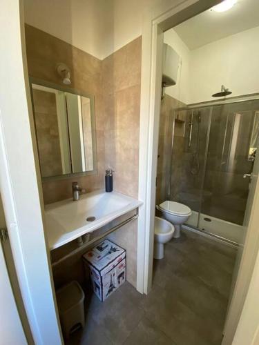 a bathroom with a sink and a toilet and a shower at Appartamento Note di Jesi in Iesi