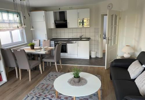 a living room with a couch and a table at Fewo Aurora im Haus Nautilus in Wangerooge