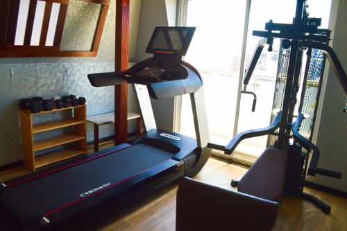 a gym with a treadmill and a exercise bike at Avoca Inn in Hulhumale