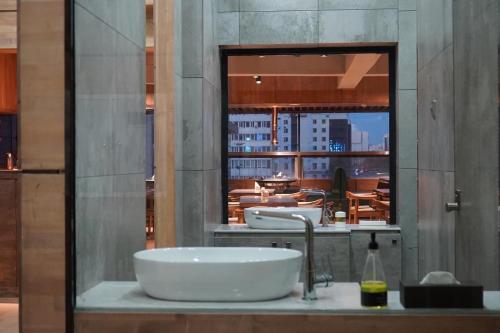 a bathroom with two sinks and a large window at HostelOne in Ulaanbaatar