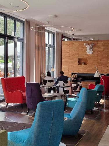 a living room filled with furniture and a large window at Grimm's Potsdamer Platz in Berlin