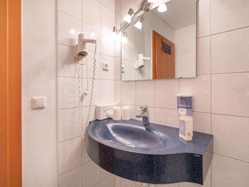 a bathroom with a sink and a mirror at Beautiful Apartment in Stubaital in a quiet location in Neustift im Stubaital