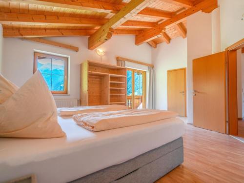 a large bedroom with two beds and wooden ceilings at Wonderful Apartment in Stubaital with Ski Boot Heaters in Neustift im Stubaital