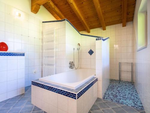 a large bathroom with a tub and a shower at Wonderful Apartment in Stubaital with Ski Boot Heaters in Neustift im Stubaital