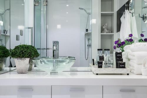 a bathroom counter with a sink and a mirror at BYD Lofts - Boutique Hotel & Serviced Apartments - Patong Beach, Phuket in Patong Beach