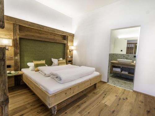 a bedroom with a large bed and a bathroom at Amazing Apartment in Neustift im Stubaital near Ski Lift in Neustift im Stubaital