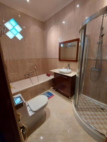 a bathroom with a toilet and a sink and a shower at Villa D3 Bukit Cijulang in Bogor