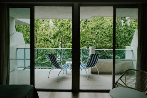 a room with two chairs and a table on a balcony at Blaumar Hotel in Salou