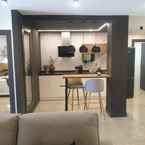 a kitchen with a table and chairs in a room at Urbanlux Olimpia Familiar in Albacete
