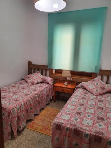 a room with two beds and a large screen at Casa Celedonio in Cerredo