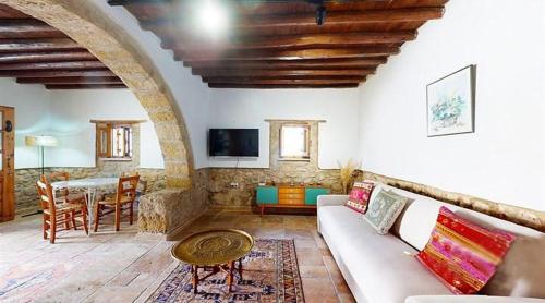 a living room with a couch and a table at Templos Homes in Kérynia