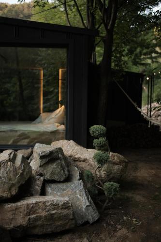 a pile of rocks in front of a building at KONTAINERLOFT in Laz