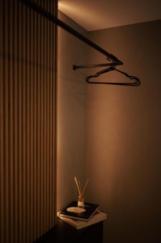 a lamp on top of a table in a room at KONTAINERLOFT in Laz