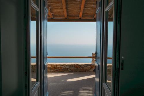 an open door to a room with a view of the ocean at Blue Calm Luxury Villa in Sifnos in Artemonas