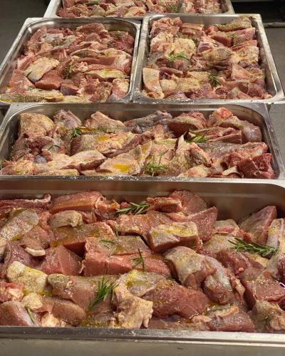 a bunch of meat in trays on a table at VILA DISHA in Tirana