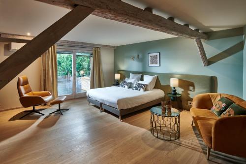 a bedroom with a bed and a living room at Pêche de Vigne & Spa in Rodern