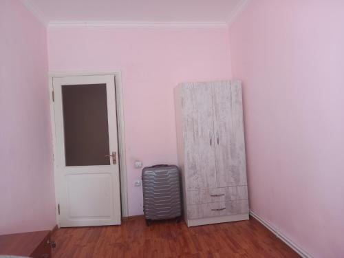an empty room with a door and a suitcase at Malacia apartments in Yerevan