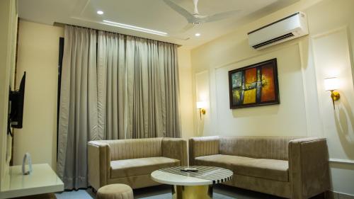 a living room with a couch and a table at Royal 9 hotel & Banquet in Meerut