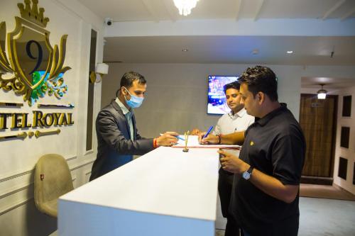 a group of men standing around a white table at Royal 9 hotel & Banquet in Meerut