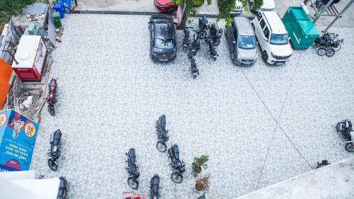 an overhead view of a parking lot with cars and motorcycles at Royal 9 hotel & Banquet in Meerut