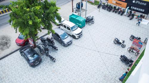 a group of cars and motorcycles parked on a street at Royal 9 hotel & Banquet in Meerut