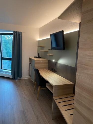 TV a/nebo společenská místnost v ubytování Hotel Corsten