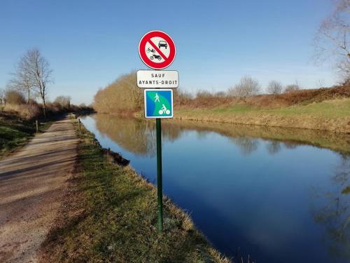 a sign on the side of a river with a no swimming sign at Le Sophora in Chéu