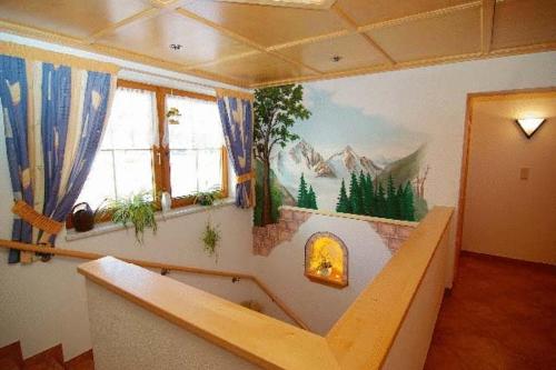 a room with a wall with a mural of mountains at Arenablick in Zell am Ziller