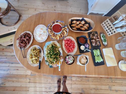 a table with a bunch of different types of food at Neitsijärve majutus in Otepää