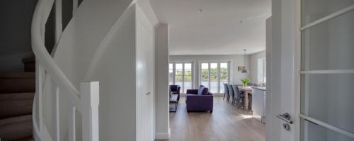 a hallway with a living room and a dining room at Rantum Dorf - Ferienappartments im Reetdachhaus 3 & 4 in Rantum