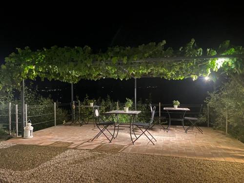 a table and chairs on a patio at night at Podere Belsogno in Montalcino