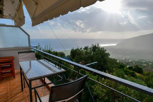 a balcony of a house with a table and chairs at Villa Ani in Borsh