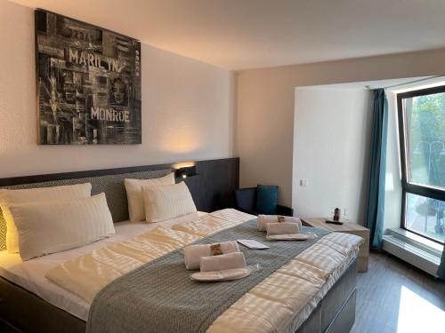 - une chambre avec un grand lit et 2 serviettes dans l'établissement Hotel Corsten, à Heinsberg