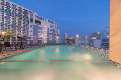 a swimming pool on the roof of a building at Zenia Boutique Hotel Nha Trang in Nha Trang
