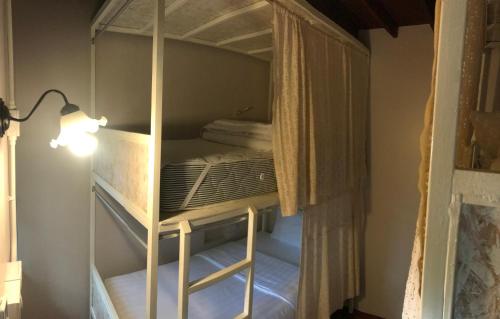 a room with a bunk bed with a light on at Insight Hostel in Chiang Mai