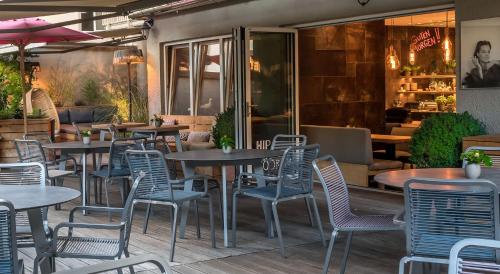 a group of tables and chairs in a restaurant at Bavaria Boutique Hotel in Munich
