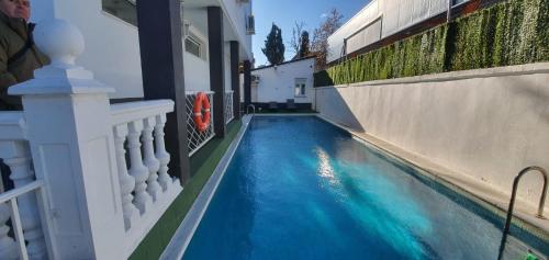 una piscina accanto a un edificio con acqua blu di Escala Suites a Madrid