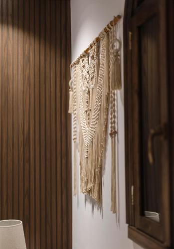 a bunch of items hanging on a wall at Vila Helen in Voskopojë