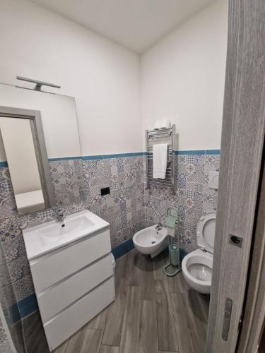 a bathroom with a sink and a toilet at Pigneto Square Home in Rome