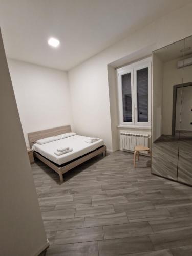 a bedroom with a bed and a glass shower at Pigneto Square Home in Rome