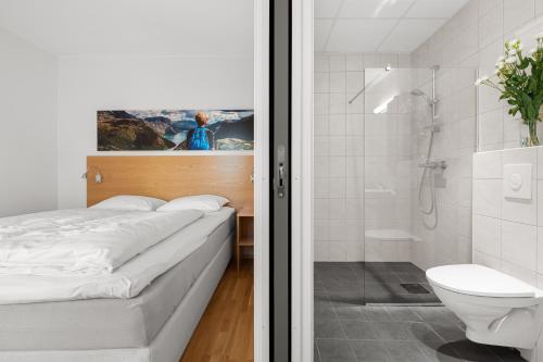 a bathroom with a bed and a shower and a toilet at Frogner House - Lagårdsveien 115 in Stavanger