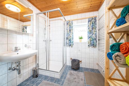 a bathroom with a shower and a sink at Ferienhaus Schwöllerbauer in Sankt Martin am Grimming