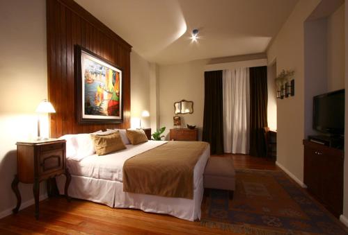 a bedroom with a large bed and a television at Legado Mitico Buenos Aires in Buenos Aires