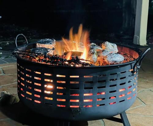 a fire pit with flames in it on a patio at Montrose Hilltop Garden Retreat in Rosetta