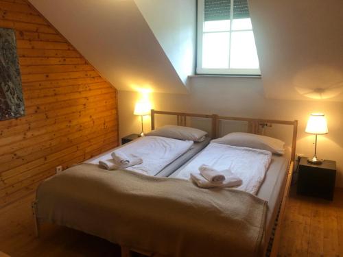 a bedroom with a bed with two towels on it at Winzerhaus mit Fernblick in Krems an der Donau