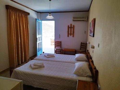 Ένα ή περισσότερα κρεβάτια σε δωμάτιο στο Poseidon Hotel 