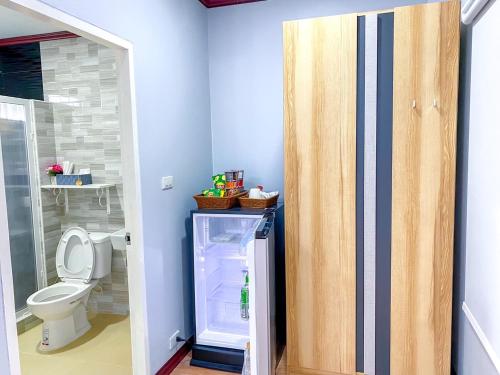 a bathroom with a refrigerator and a toilet at The memory luxury resort 