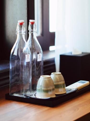 two glass bottles on a tray on a table at Hoianese Center Hotel - Truly Hoi An in Hoi An