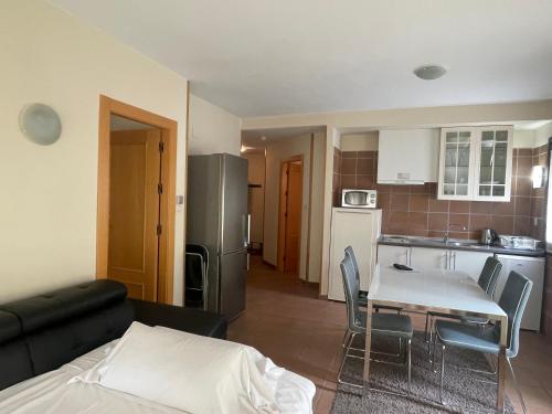 a living room with a couch and a table and a kitchen at Apartamentos Boabdil in Sierra Nevada